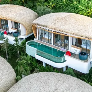 Aerial view of the luxurious Three Monkeys Villas in Phuket, featuring unique architecture and private infinity pools surrounded by lush greenery.
