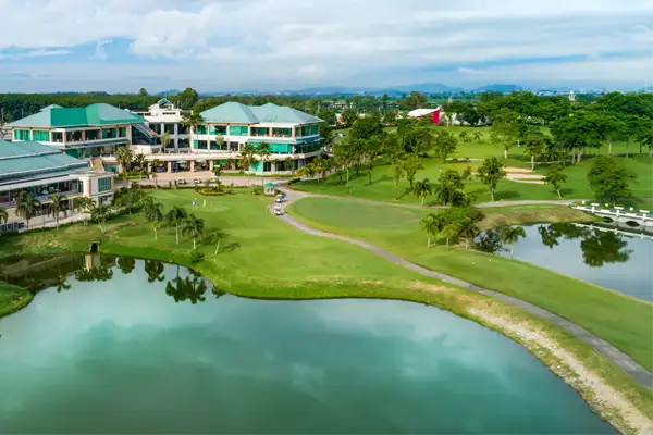 Pattana Sports Resort in Chonburi, a golf partner of Fairways of Eden, featuring a stunning clubhouse, lush fairways, and water hazards for an exciting golf experience.