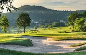 Scenic view of Springfield Royal Country Club in Hua Hin, showcasing lush fairways, sand bunkers, and rolling hills.