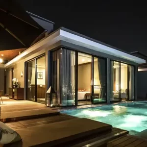 Luxury private villa with a pool at V Villas Hua Hin, illuminated beautifully at night for a serene and exclusive retreat.