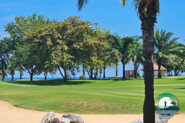 Palm-lined fairway at Seapine Beach Golf and Resort Hua Hin with sea views beyond